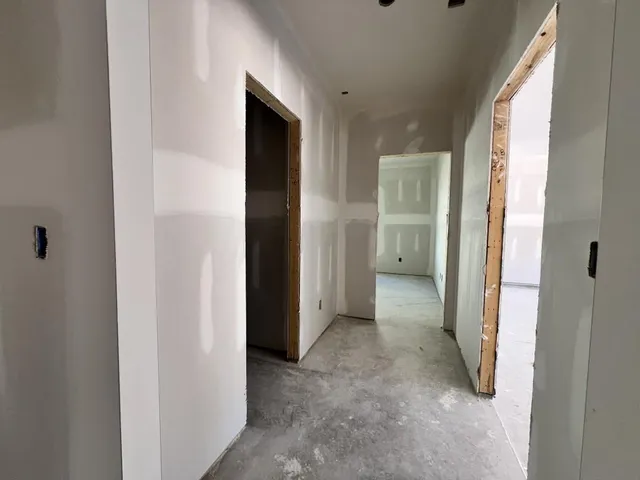 a view of a hallway with wooden shelves