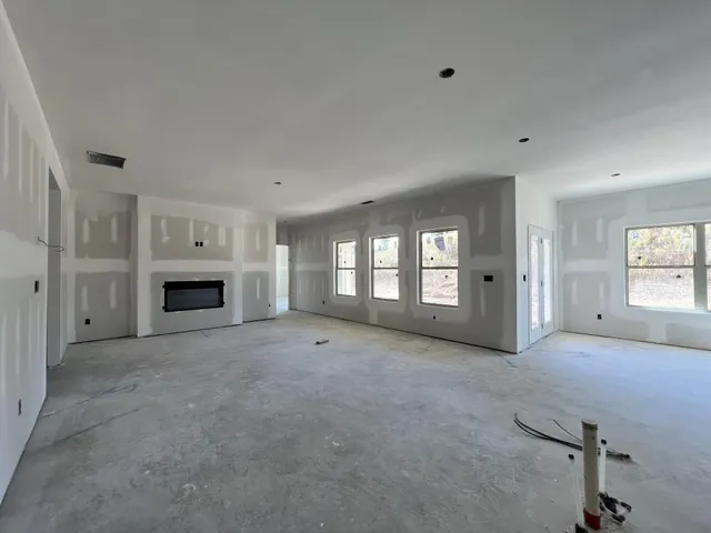 a view of empty room with a fireplace