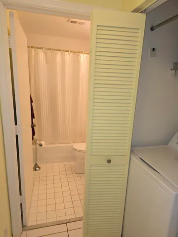 a bathroom with a sink a toilet a tub and shower