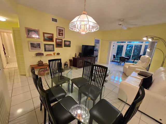 a view of a dining room with furniture and chandelier