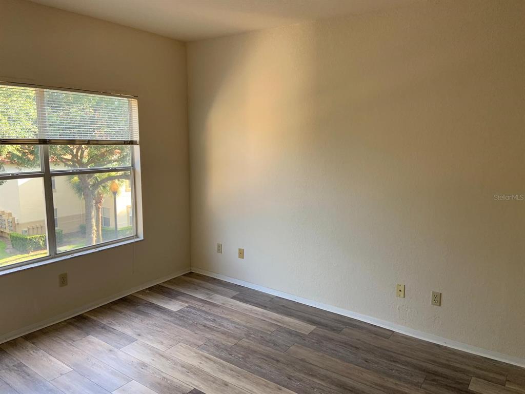 831 Camargo Way, Unit 311 Altamonte Springs, FL 32714 - Photo 12 of 28 an empty room with wooden floor and windows