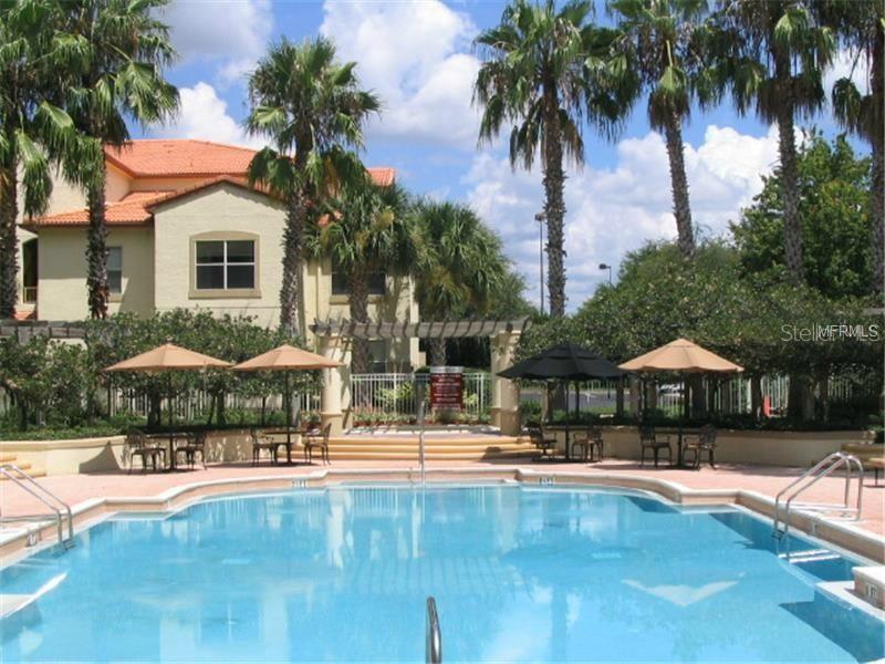 831 Camargo Way, Unit 311 Altamonte Springs, FL 32714 - Photo 20 of 28 a swimming pool with outdoor seating and yard