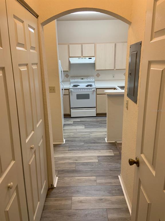 831 Camargo Way, Unit 311 Altamonte Springs, FL 32714 - Photo 3 of 28 a kitchen with a refrigerator a stove top oven and cabinets