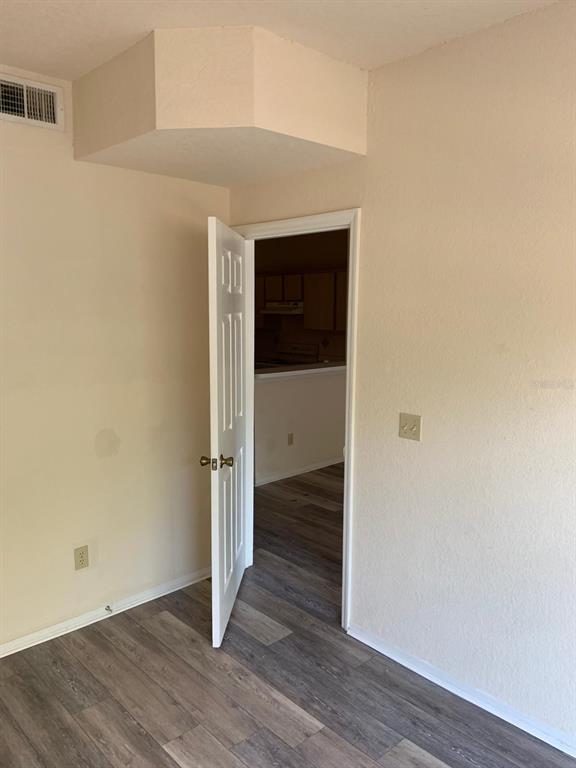 831 Camargo Way, Unit 311 Altamonte Springs, FL 32714 - Photo 9 of 28 a view of an empty room with wooden floor