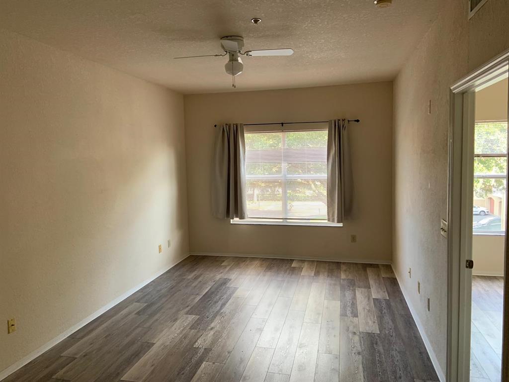 831 Camargo Way, Unit 311 Altamonte Springs, FL 32714 - Photo 10 of 28 an empty room with wooden floor and windows