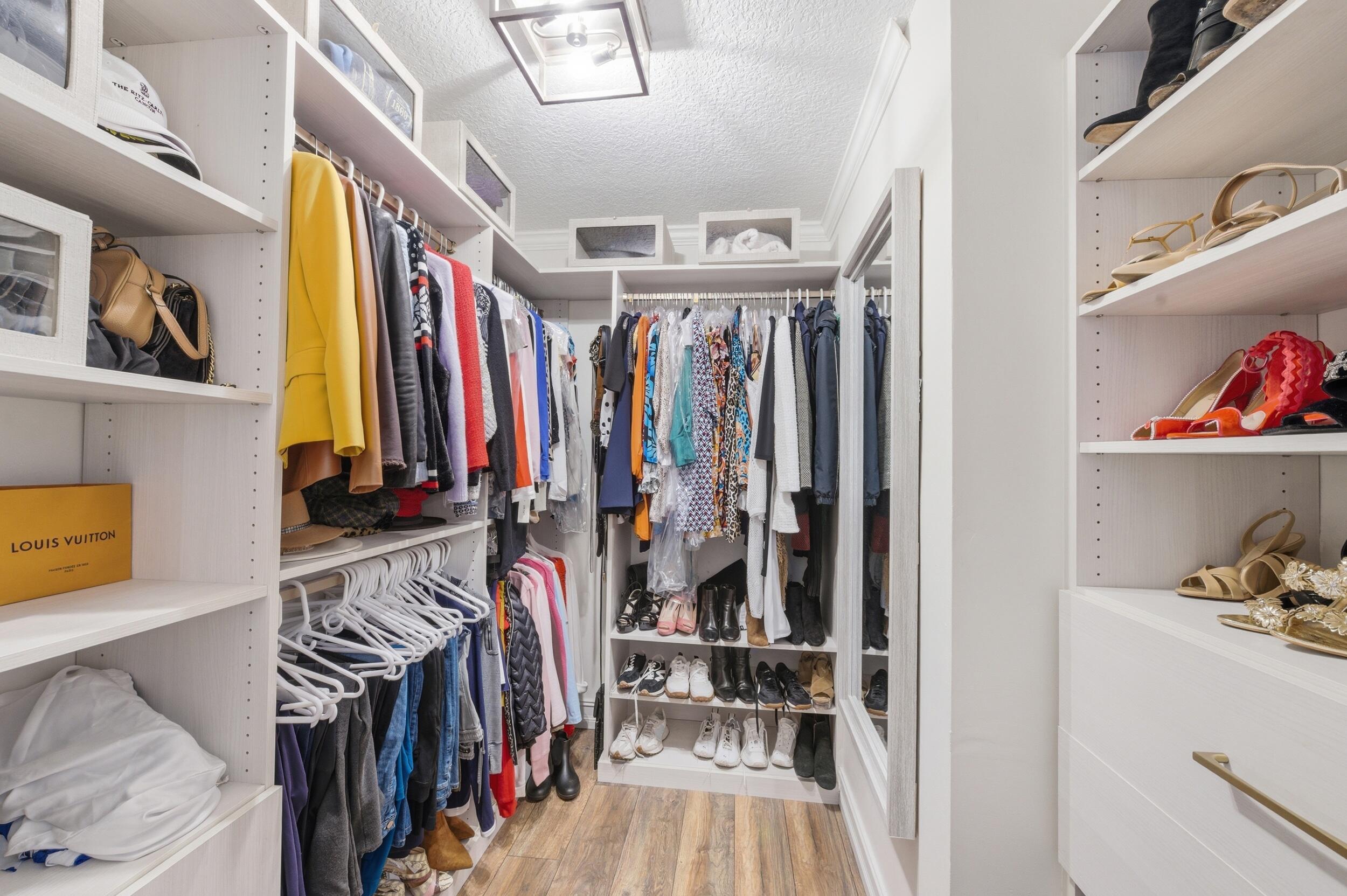 4780 Brandywine Drive Boca Raton, FL 33487 - Photo 18 of 43 a view of walk in closet with clothes and shoes