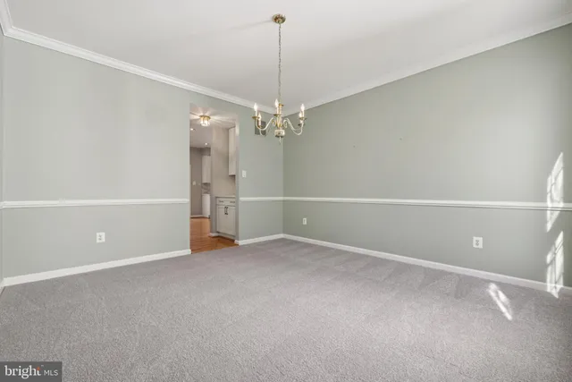 a view of a hallway with windows and entryway