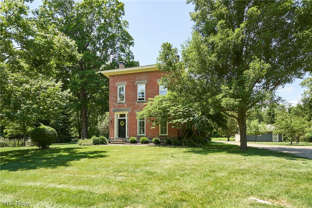5046 Alger Road Richfield, OH 44286 - Photo 45 of 49 Classic brick facade residence with a prominent entryway, framed by mature trees