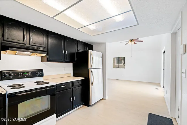 a kitchen with stainless steel appliances a stove a refrigerator and a refrigerator