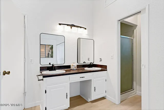 a bathroom with a double vanity sink and mirror