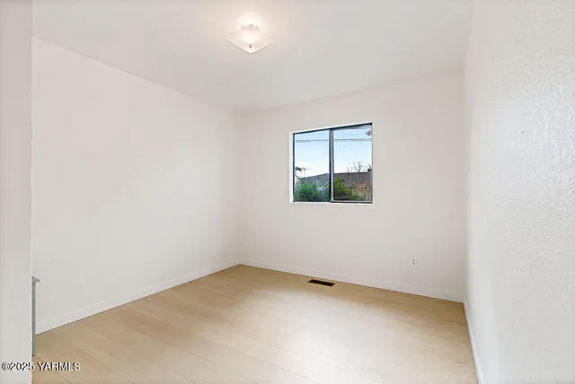 a bathroom with a granite countertop sink toilet and a mirror