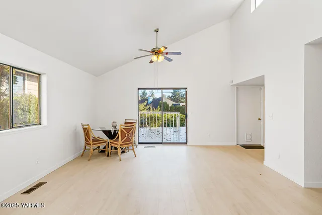 a view of a livingroom with workspace and a window