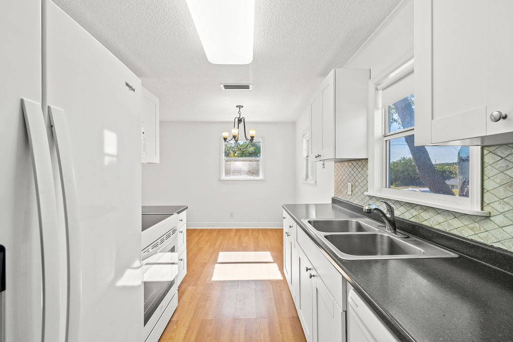 344 13th Place Southwest Vero Beach, FL 32962 - Photo 13 of 30 a kitchen that has a sink a window and stainless steel appliances