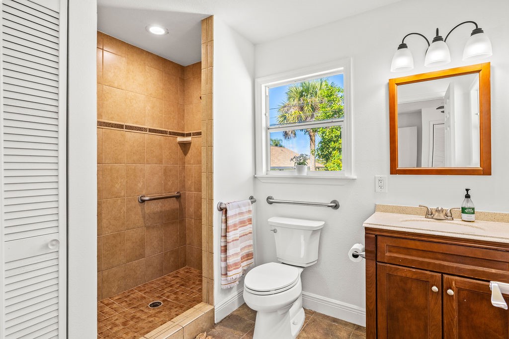 344 13th Place Southwest Vero Beach, FL 32962 - Photo 15 of 30 a bathroom with a granite countertop sink toilet and shower