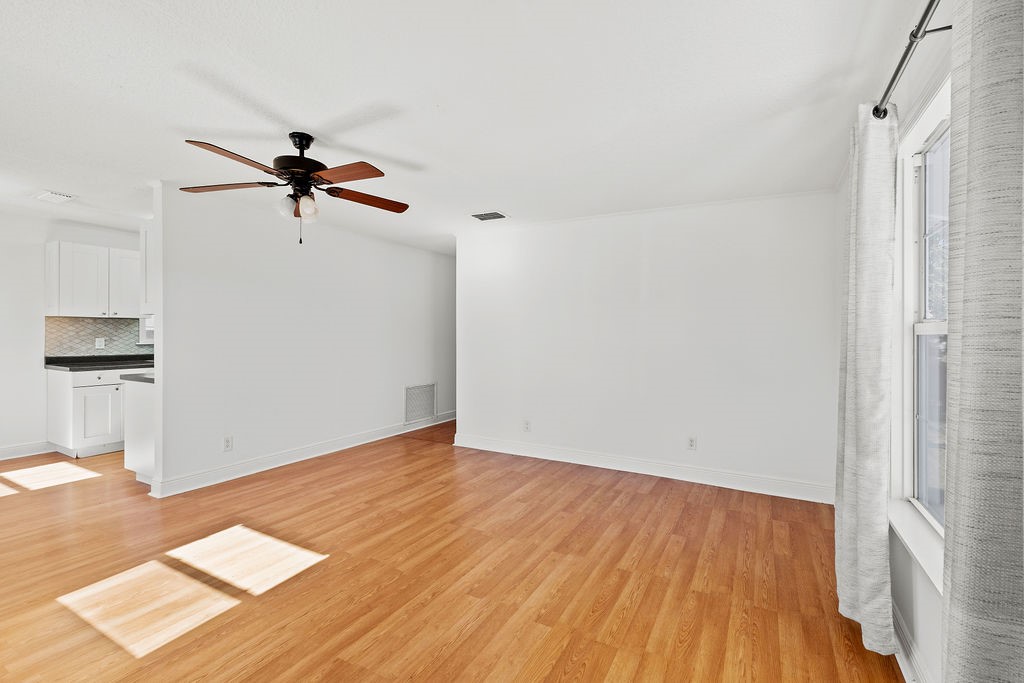 344 13th Place Southwest Vero Beach, FL 32962 - Photo 5 of 30 a view of room with hardwood floor and a ceiling fan