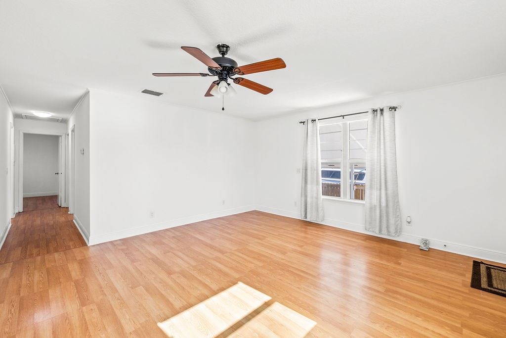 344 13th Place Southwest Vero Beach, FL 32962 - Photo 6 of 30 a view of empty room with wooden floor and fan