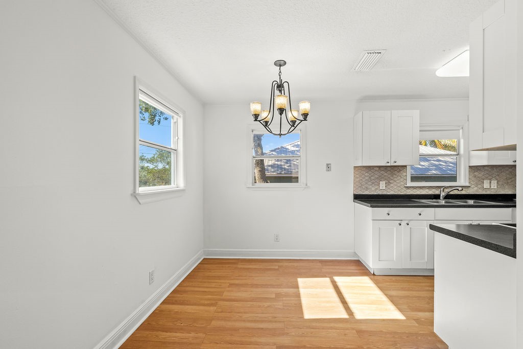 344 13th Place Southwest Vero Beach, FL 32962 - Photo 9 of 30 a kitchen with stainless steel appliances granite countertop a sink and a stove