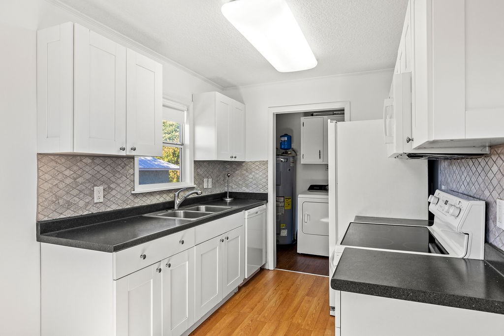 344 13th Place Southwest Vero Beach, FL 32962 - Photo 10 of 30 a kitchen with stainless steel appliances granite countertop a sink stove and refrigerator
