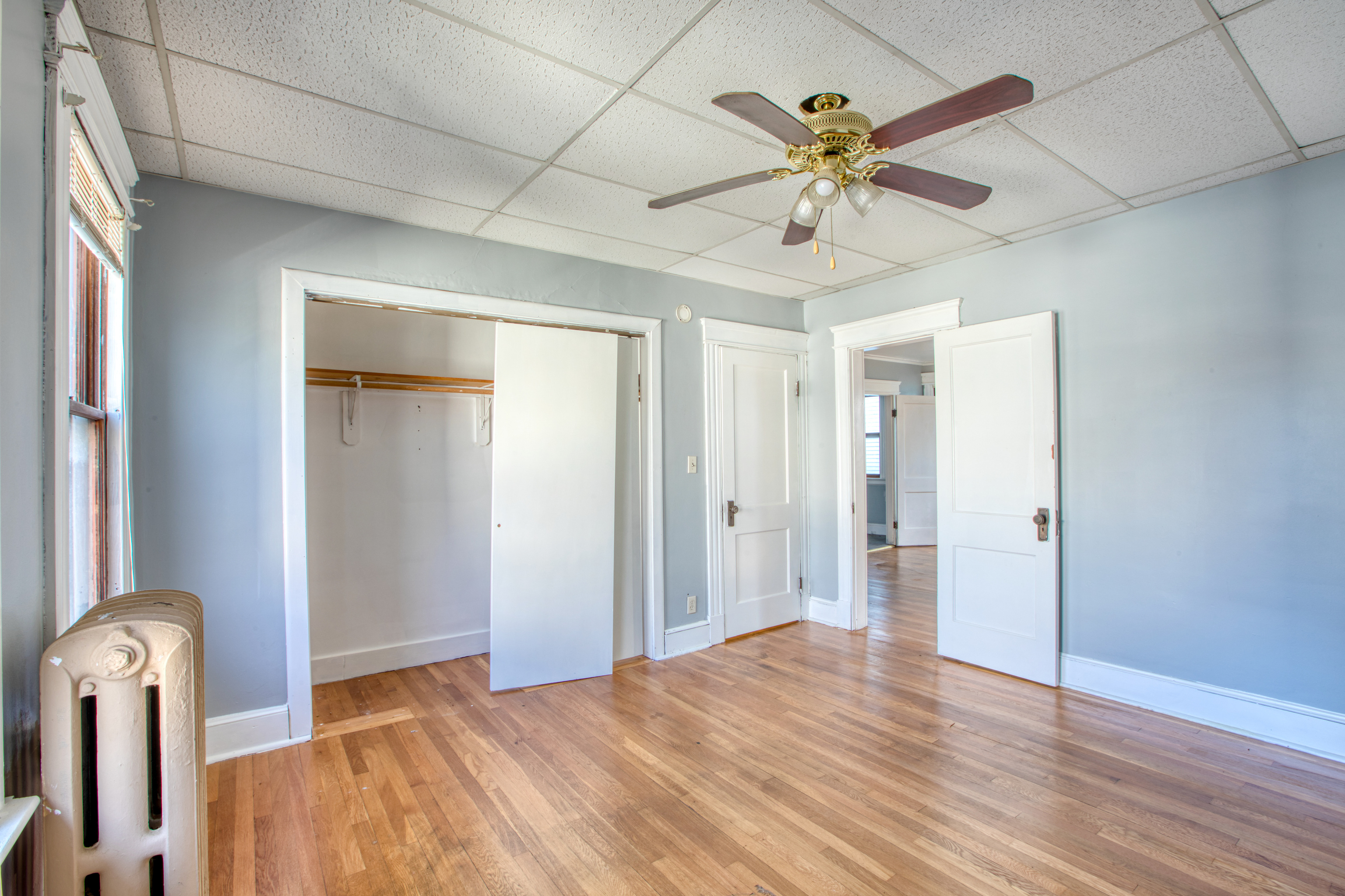 226 Ledgeside Avenue, Unit 228 Waterbury, CT 06708 - Photo 14 of 19 a view of empty room with wooden floor and ceiling fan