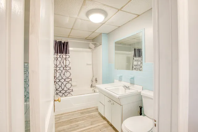 a bathroom with a sink toilet and shower