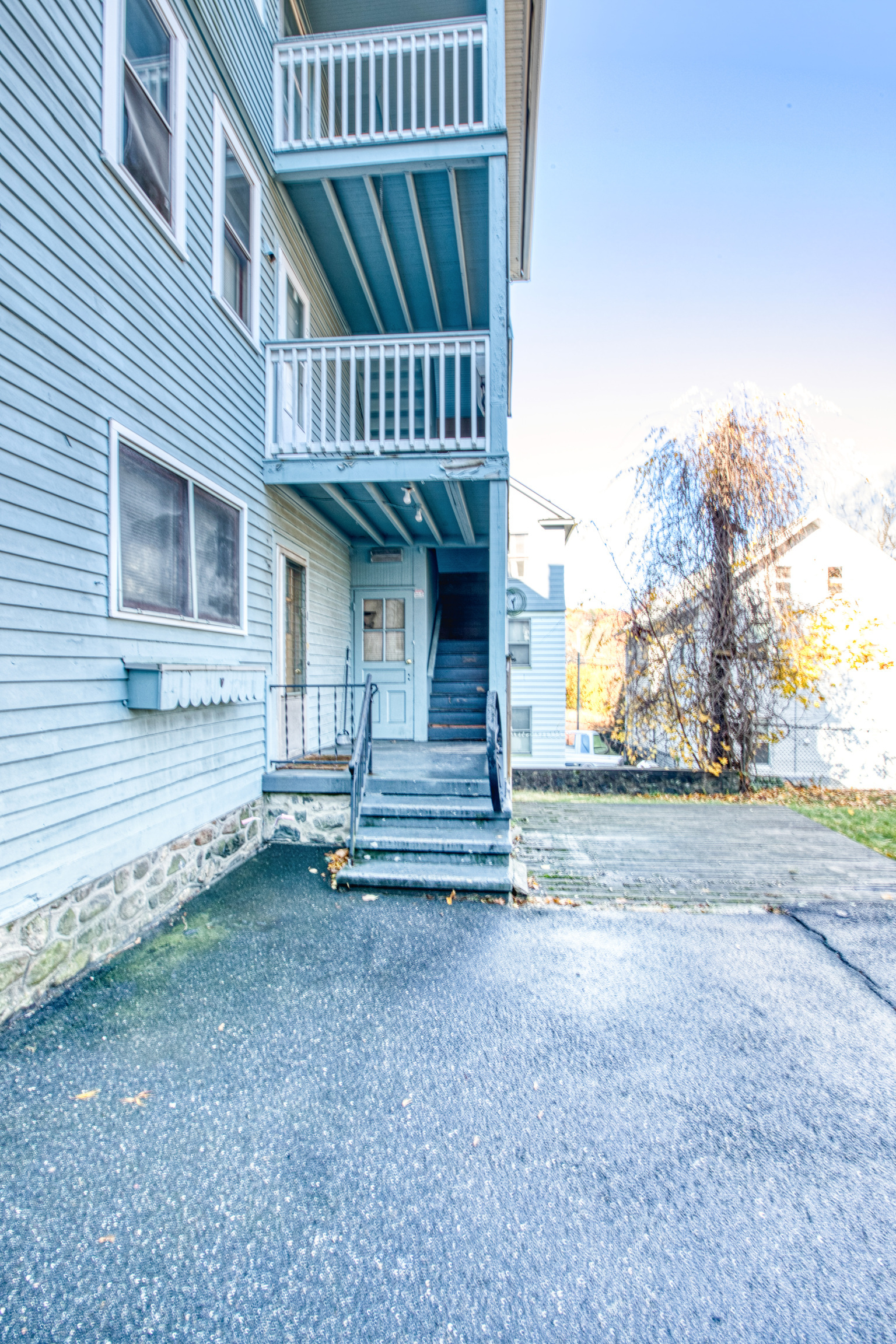 226 Ledgeside Avenue, Unit 228 Waterbury, CT 06708 - Photo 18 of 19 a view of a house with wooden floor and fence