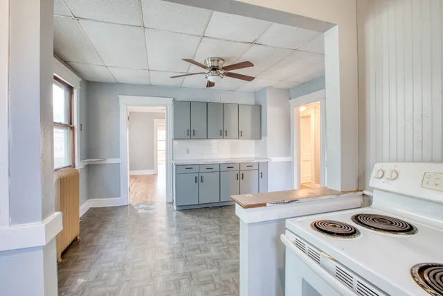 a kitchen with a stove a sink and a refrigerator
