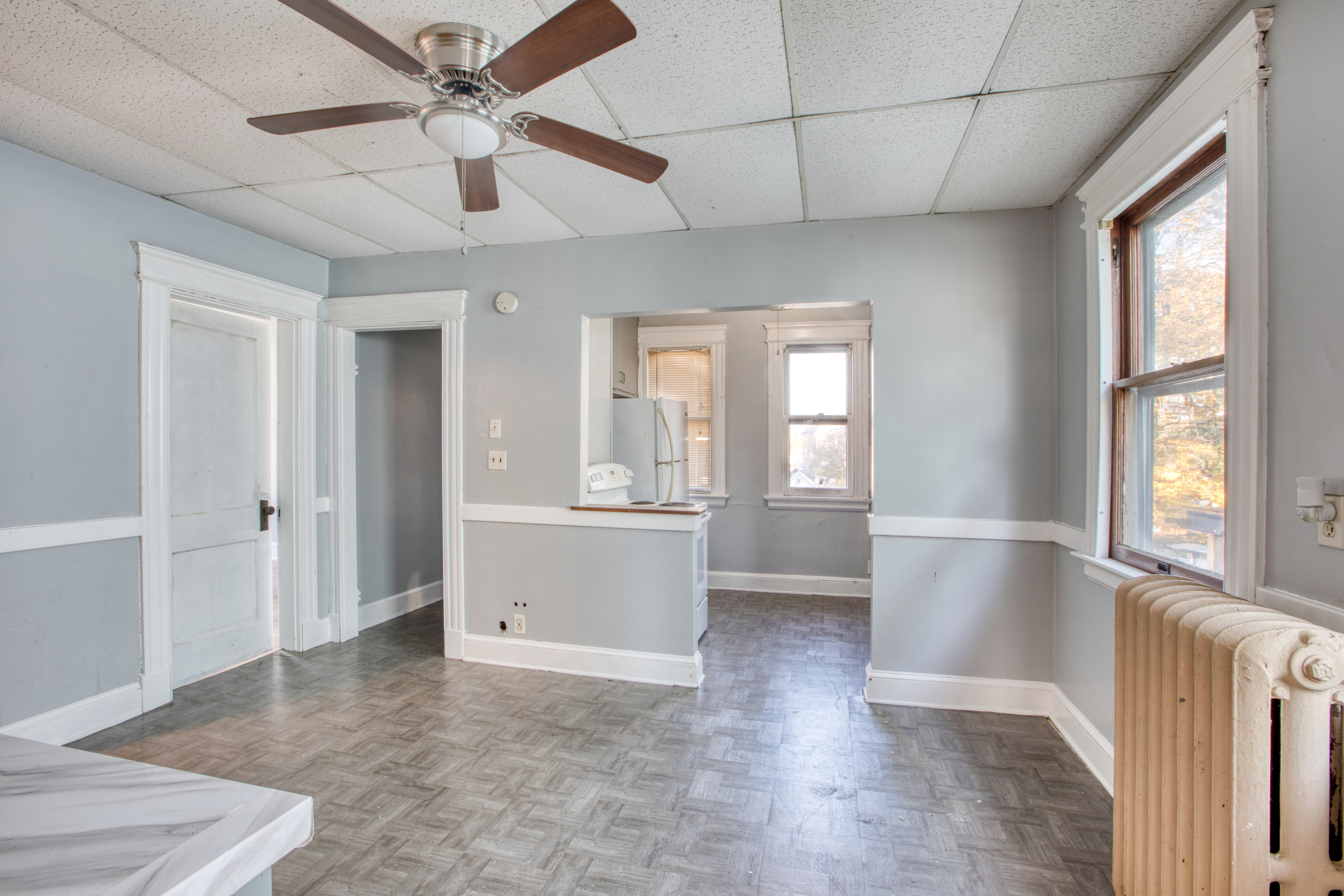 226 Ledgeside Avenue, Unit 228 Waterbury, CT 06708 - Photo 4 of 19 a view of an empty room with a window and a kitchen view