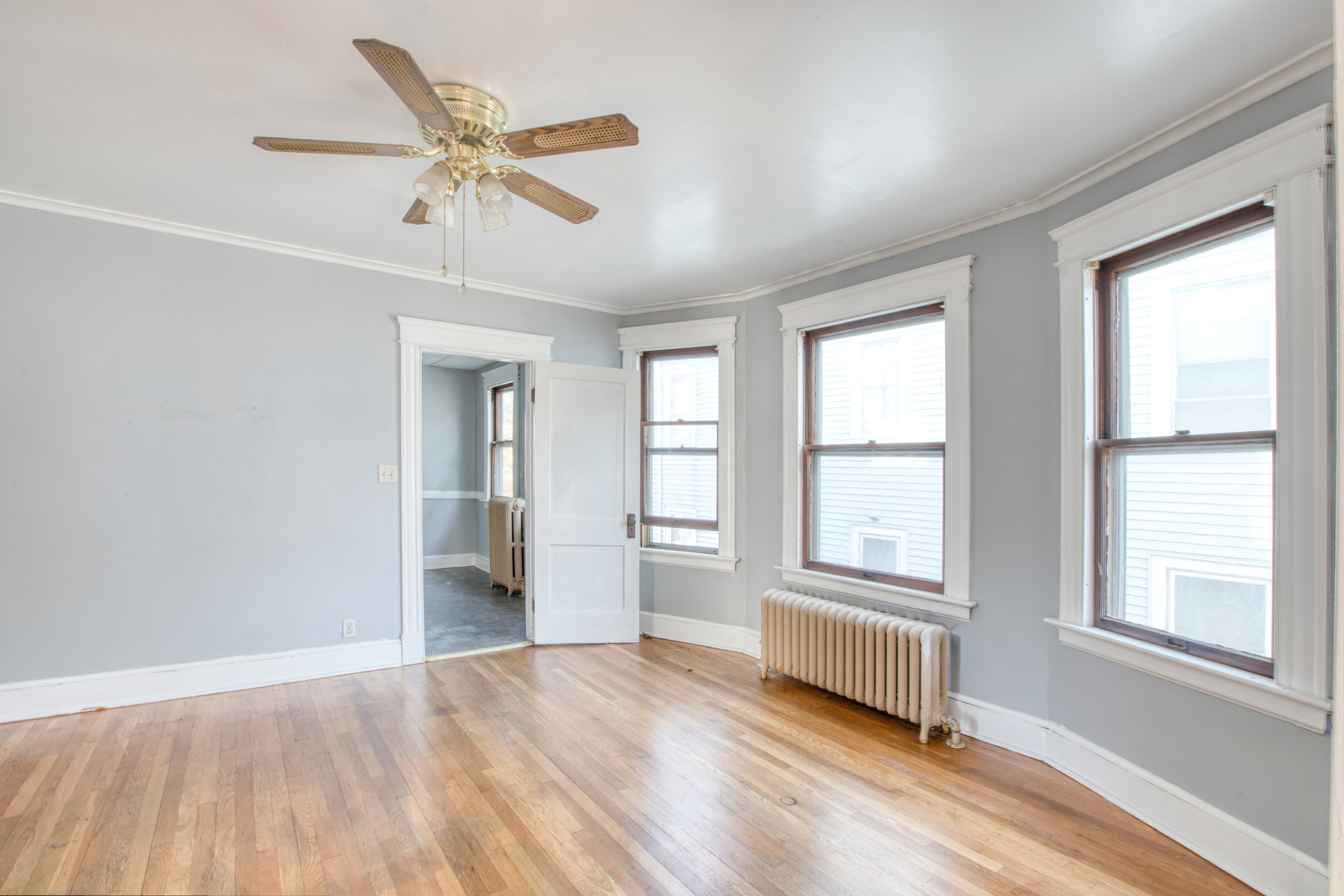 226 Ledgeside Avenue, Unit 228 Waterbury, CT 06708 - Photo 5 of 19 a view of an empty room with a window and wooden floor