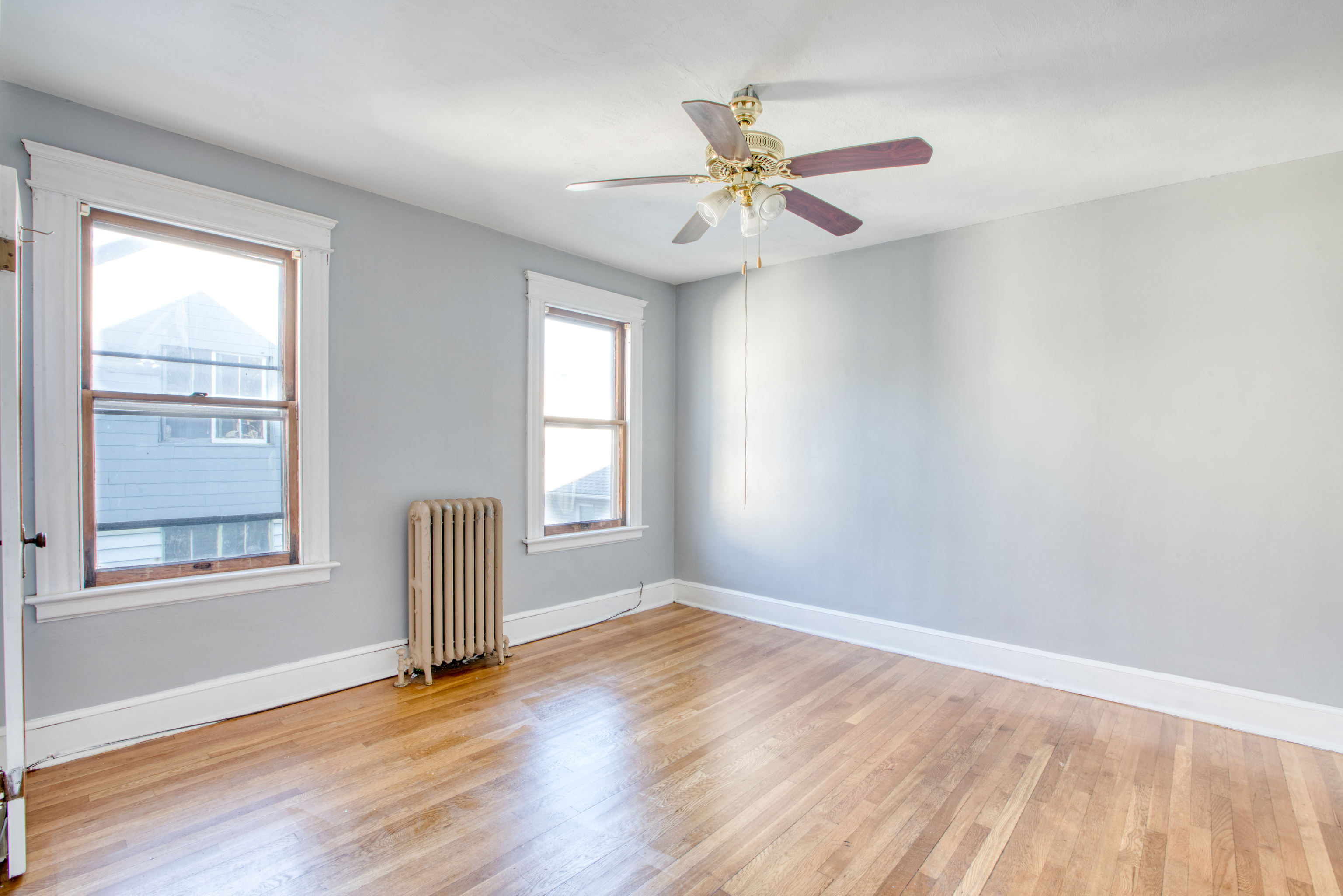 226 Ledgeside Avenue, Unit 228 Waterbury, CT 06708 - Photo 9 of 19 an empty room with wooden floor fan and windows