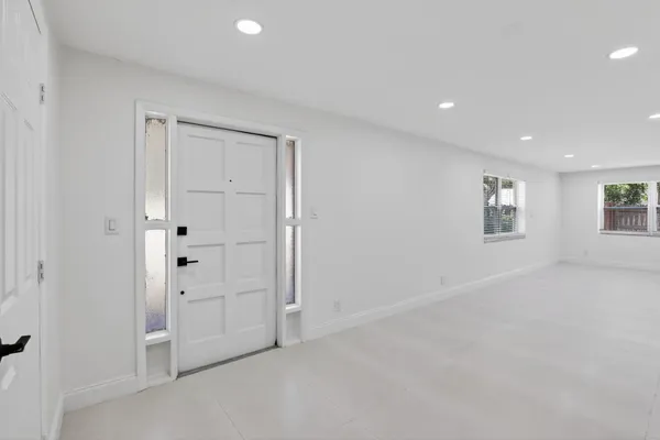 an empty room with a empty space and windows