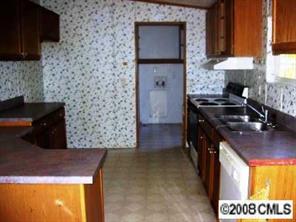 3240 Shue Road Salisbury, NC 28147 - Photo 3 of 8 a kitchen with a sink and a stove