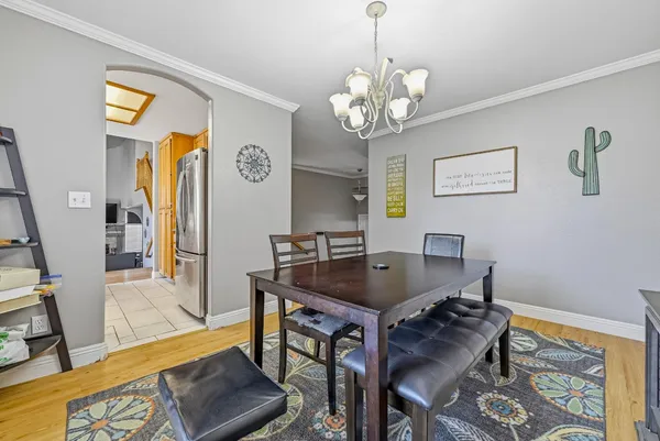 a view of a dining room with furniture and a chandelier