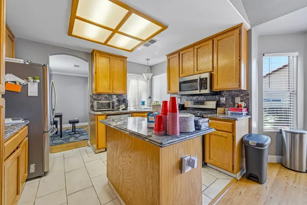 a kitchen that has a sink and a stove in it