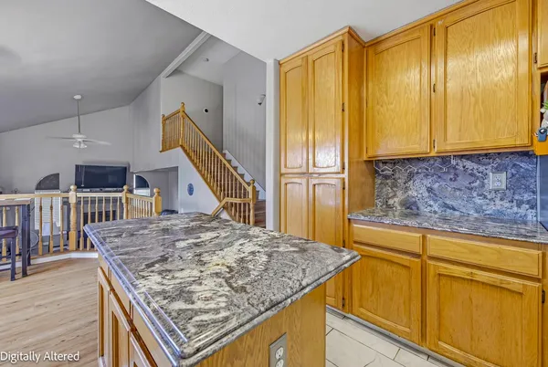 a view of kitchen island and wooden floor