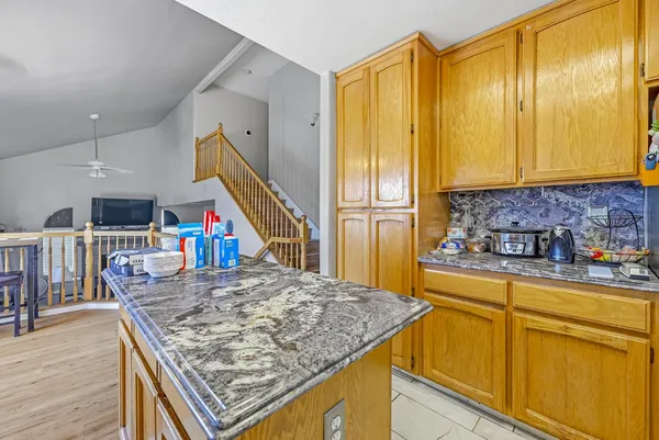 a kitchen with stainless steel appliances granite countertop a sink and cabinets