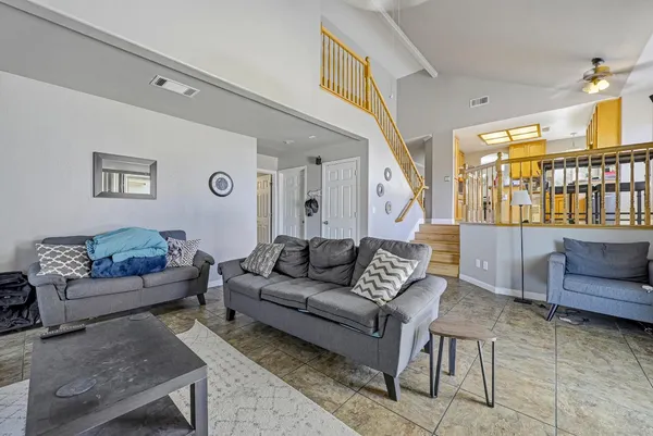 a living room with furniture and a wooden floor