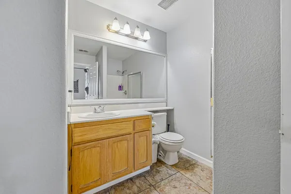 a bathroom with a sink toilet and a mirror
