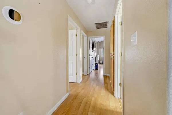 a view of a room with wooden floor