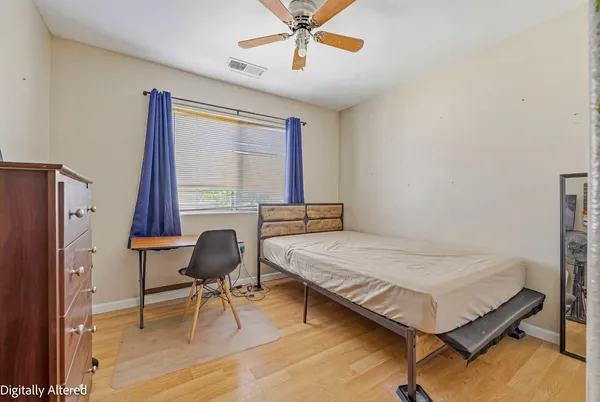 a bedroom with a bed window and a desk