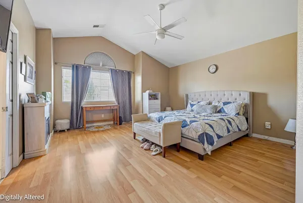 a bedroom with a bed mirror and a window