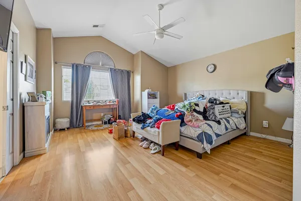 a bedroom with furniture and a wooden floor