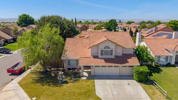 an aerial view of a house with swimming pool garden and outdoor seating
