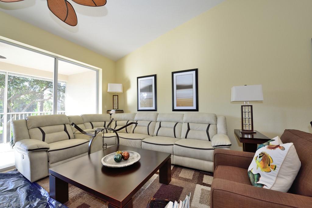 8125 Celeste Drive, Unit 5216 Naples, FL 34113 - Photo 2 of 11 a living room with furniture and a large window