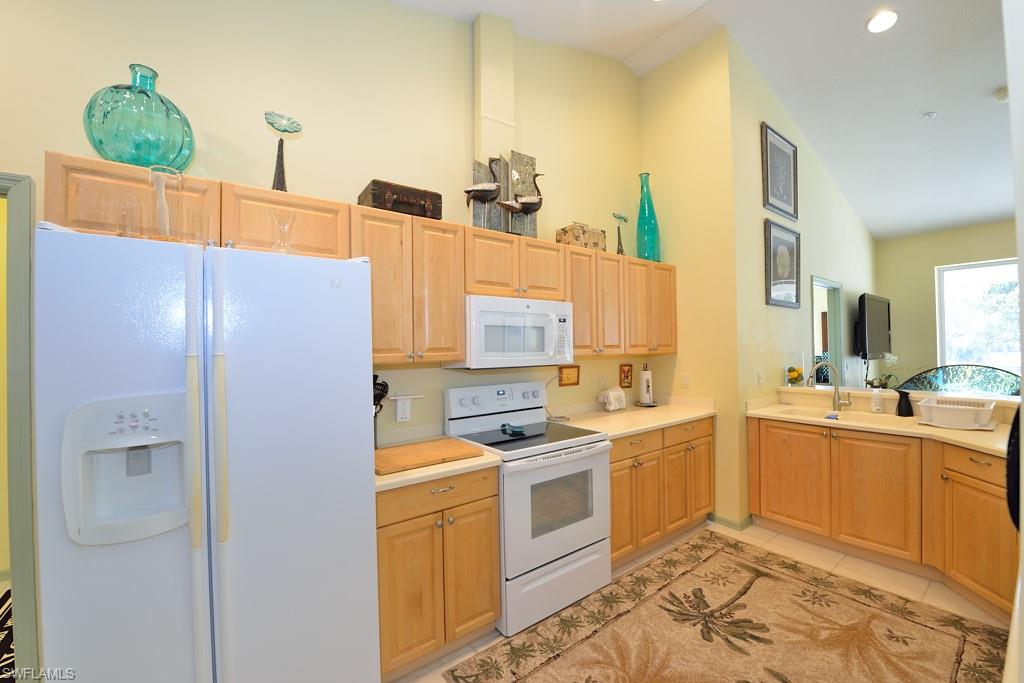 8125 Celeste Drive, Unit 5216 Naples, FL 34113 - Photo 5 of 11 a kitchen that has a sink and cabinets
