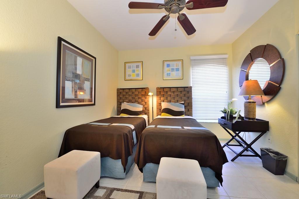 8125 Celeste Drive, Unit 5216 Naples, FL 34113 - Photo 9 of 11 a bedroom with two beds and painting on the wall