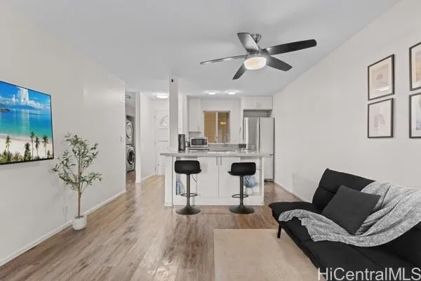 a view of a livingroom with furniture and a ceiling fan