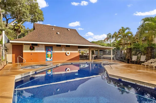 a view of a patio with table and chairs with wooden floor and fence