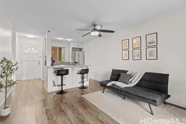 a living room with furniture and kitchen view