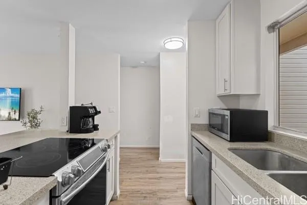 a kitchen with granite countertop a stove and a sink