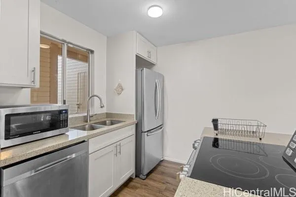 a kitchen with stainless steel appliances granite countertop a refrigerator and a sink
